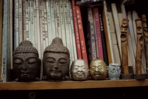 Buddha heads and books: Shelf shot from a cluttered shop in Insadong, Seoul